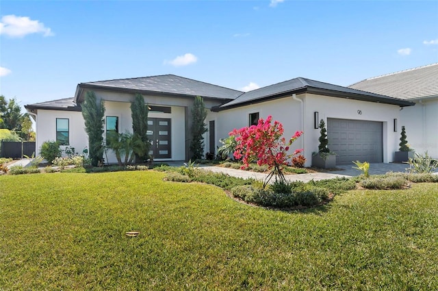 96 Del Palma Dr, Palm Coast, FL 32137 - prairie-style home with a front lawn, stucco siding, and an attached garage