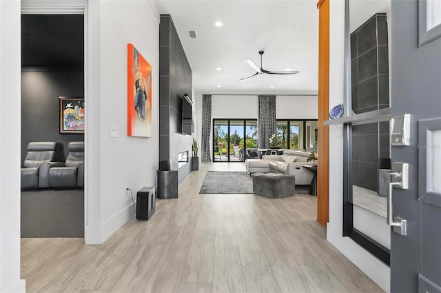 96 Del Palma Dr, Palm Coast, FL 32137 - entrance foyer featuring light wood finished floors, a fireplace with raised hearth, baseboards, visible vents, and recessed lighting