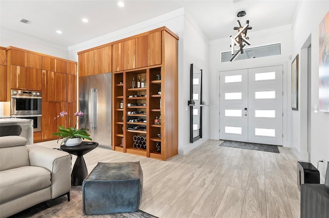 96 Del Palma Dr, Palm Coast, FL 32137 - entrance foyer with visible vents, crown molding, light wood-style flooring, and recessed lighting