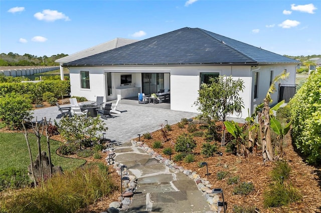 96 Del Palma Dr, Palm Coast, FL 32137 - rear view of property featuring stucco siding and a patio