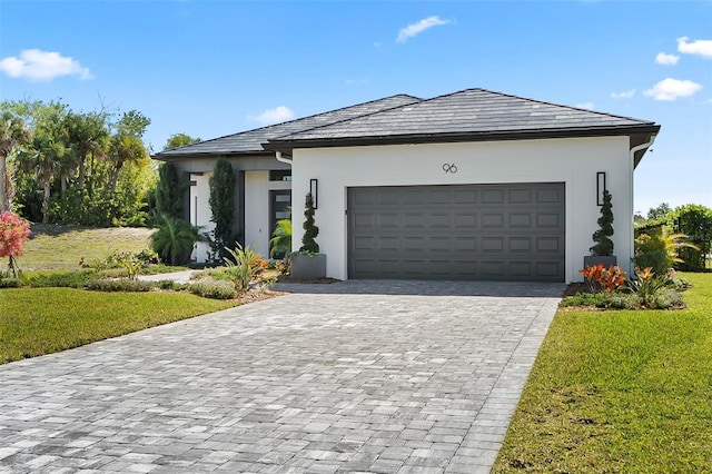 96 Del Palma Dr, Palm Coast, FL 32137 - view of front facade with stucco siding, an attached garage, a front lawn, and decorative driveway