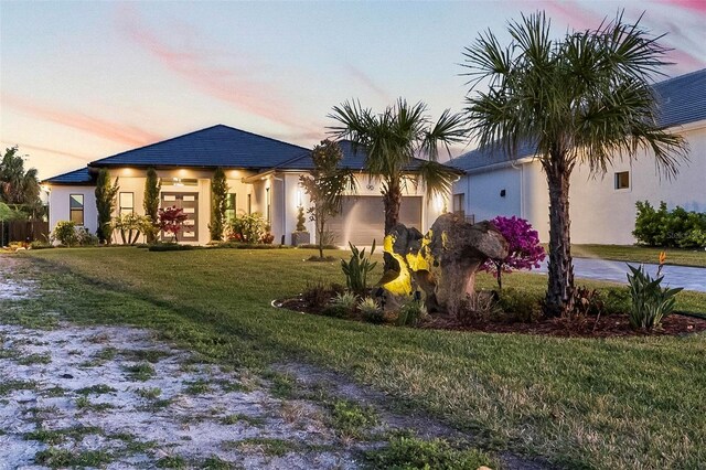 96 Del Palma Dr, Palm Coast, FL 32137 - view of front of home featuring driveway, a front yard, and stucco siding