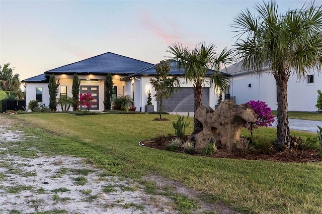 96 Del Palma Dr, Palm Coast, FL 32137 - view of front of home with a front yard, stucco siding, and an attached garage