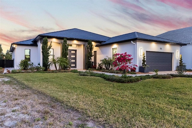 96 Del Palma Dr, Palm Coast, FL 32137 - view of front of house featuring a lawn, stucco siding, and an attached garage