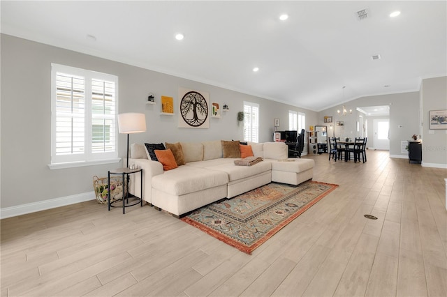 49 Narvarez Ave, Saint Augustine, FL 32084 - living area featuring crown molding, light wood-type flooring, a chandelier, vaulted ceiling, and baseboards