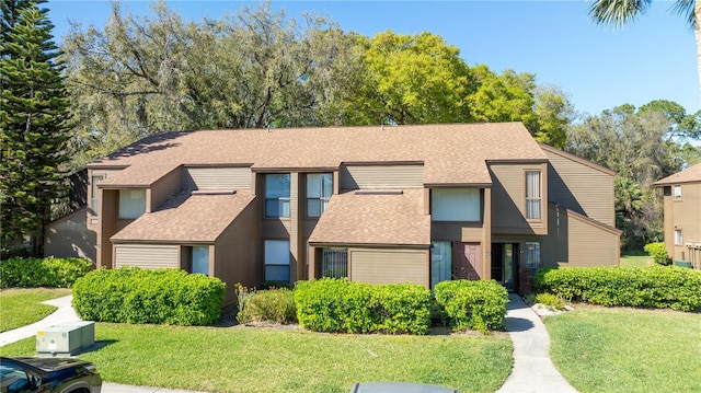 41 Oxford Ln Unit 41, Palm Coast, FL 32137 - multi unit property with a front yard and a shingled roof