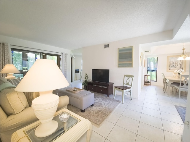 41 Oxford Ln Unit 41, Palm Coast, FL 32137 - living area featuring light tile patterned floors, visible vents, and a textured ceiling