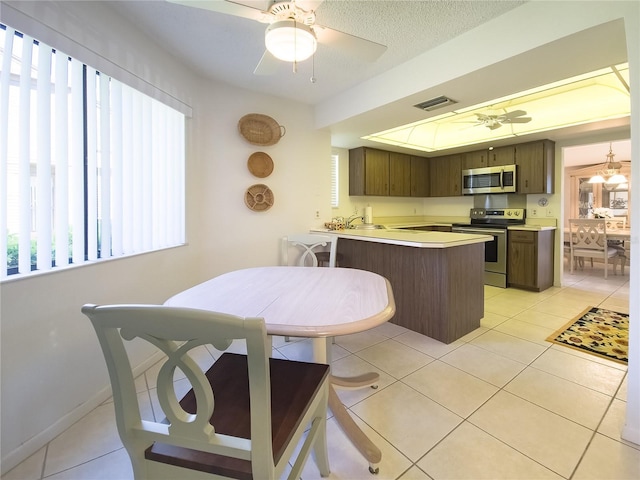 41 Oxford Ln Unit 41, Palm Coast, FL 32137 - kitchen featuring ceiling fan, a peninsula, visible vents, appliances with stainless steel finishes, and light countertops