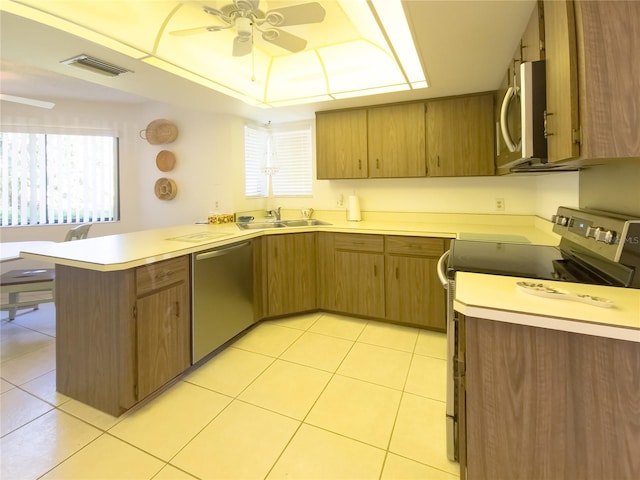 41 Oxford Ln Unit 41, Palm Coast, FL 32137 - kitchen with ceiling fan, a peninsula, visible vents, appliances with stainless steel finishes, and a sink
