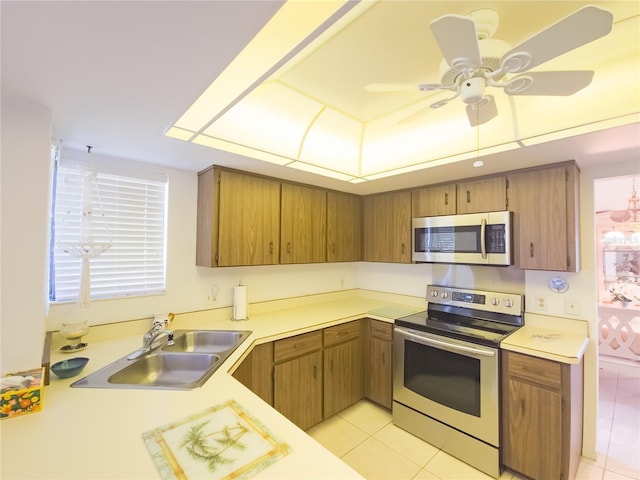 41 Oxford Ln Unit 41, Palm Coast, FL 32137 - kitchen featuring light countertops, appliances with stainless steel finishes, light tile patterned floors, and a sink