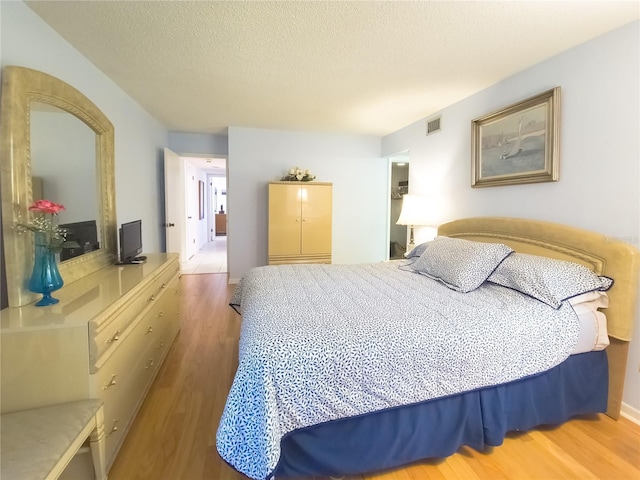 41 Oxford Ln Unit 41, Palm Coast, FL 32137 - bedroom with visible vents, a textured ceiling, and wood finished floors