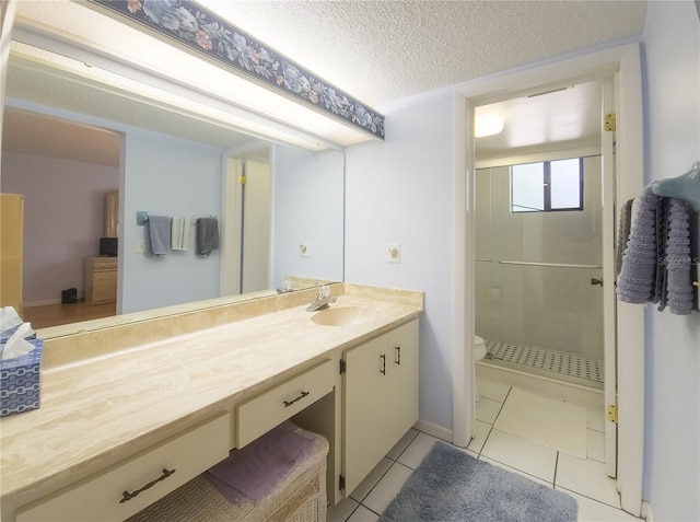 41 Oxford Ln Unit 41, Palm Coast, FL 32137 - bathroom featuring a textured ceiling, vanity, tile patterned flooring, toilet, and a stall shower