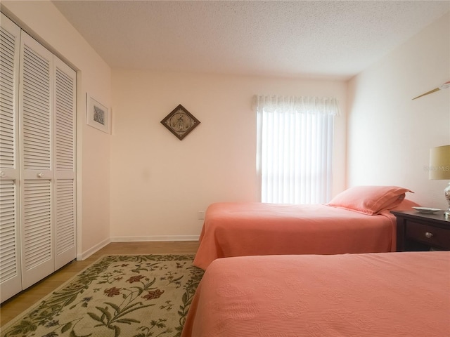 41 Oxford Ln Unit 41, Palm Coast, FL 32137 - bedroom featuring light wood-style flooring, a closet, and baseboards
