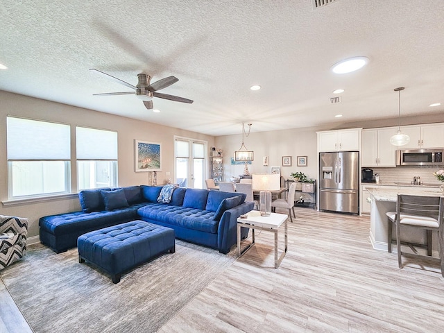 68 Los Lagos Blvd, Palm Coast, FL 32137 - living area featuring light wood finished floors, ceiling fan, a textured ceiling, and recessed lighting