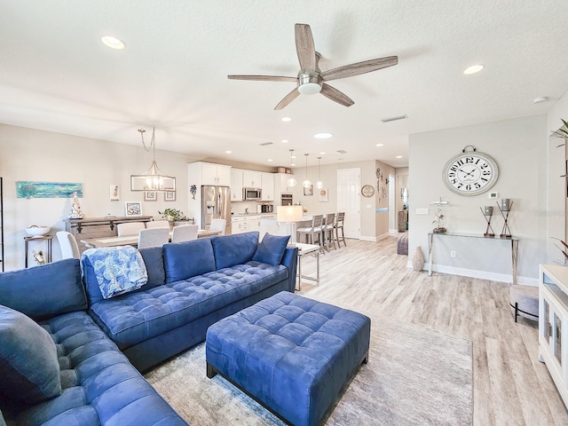 68 Los Lagos Blvd, Palm Coast, FL 32137 - living area with light wood-type flooring, ceiling fan, recessed lighting, baseboards, and a textured ceiling