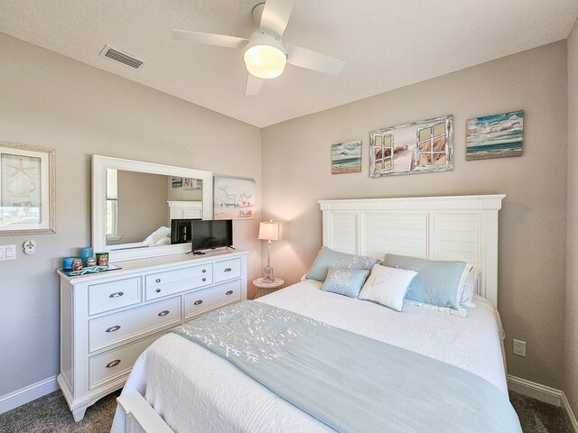 68 Los Lagos Blvd, Palm Coast, FL 32137 - bedroom featuring dark carpet, baseboards, and a ceiling fan