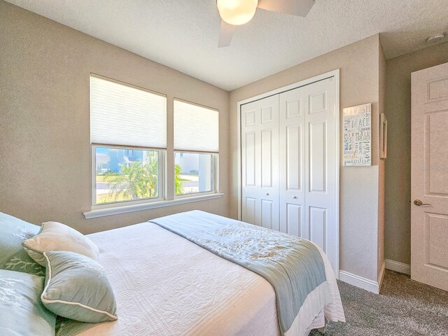 68 Los Lagos Blvd, Palm Coast, FL 32137 - bedroom with carpet, a closet, baseboards, and ceiling fan