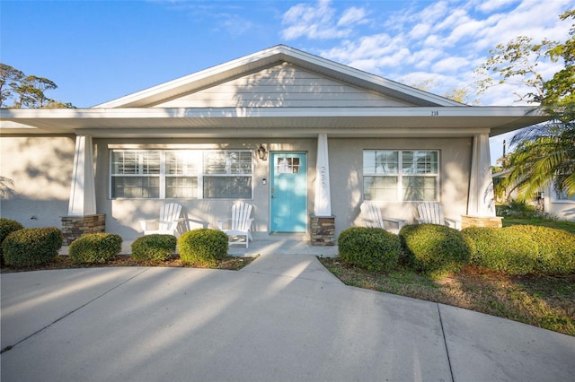 view of front of property with stucco siding and covered porch