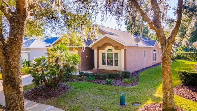 3220 Galty Cir, Ormond Beach, FL 32174 - view of front of house featuring stucco siding and a front lawn