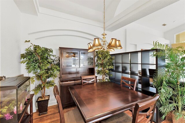 3220 Galty Cir, Ormond Beach, FL 32174 - dining area with wood finished floors and a chandelier