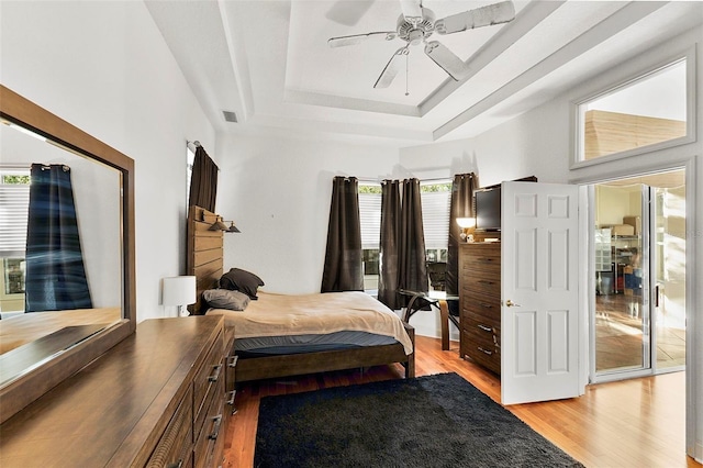 3220 Galty Cir, Ormond Beach, FL 32174 - bedroom with light wood-type flooring, a tray ceiling, and ceiling fan