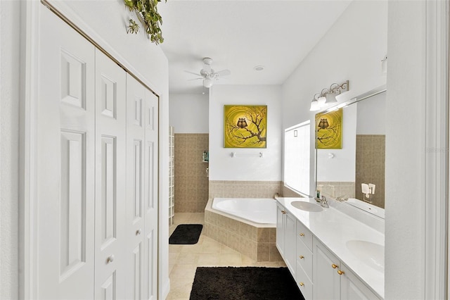 3220 Galty Cir, Ormond Beach, FL 32174 - bathroom with a closet, a bath, double vanity, tile patterned floors, and ceiling fan