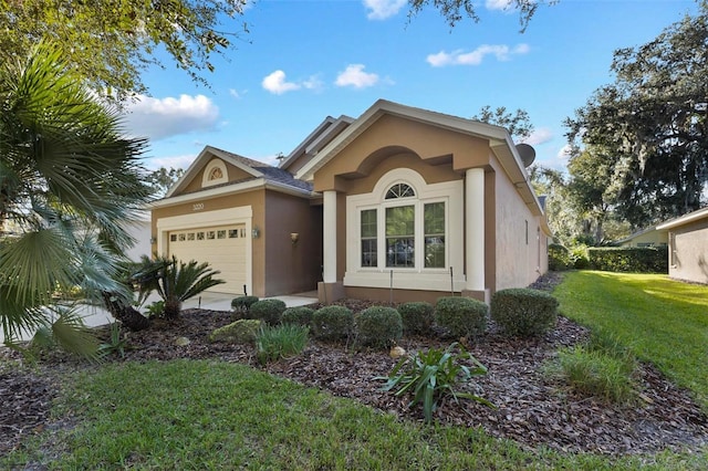 3220 Galty Cir, Ormond Beach, FL 32174 - ranch-style house with stucco siding, a garage, and a front yard