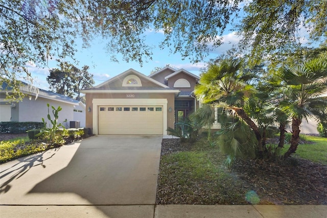 3220 Galty Cir, Ormond Beach, FL 32174 - view of front facade with stucco siding, a garage, and concrete driveway