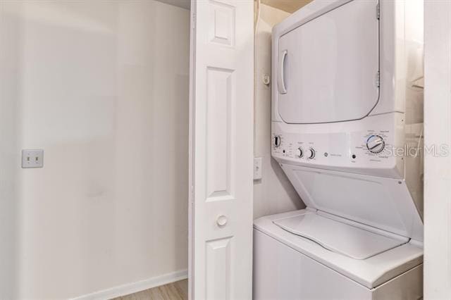 31 Catalonia Court E, Saint Augustine, FL 32086 - clothes washing area with laundry area, stacked washer and dryer, and baseboards
