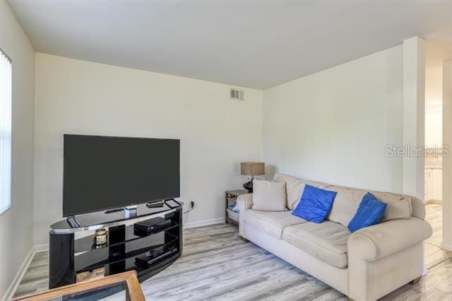 31 Catalonia Court E, Saint Augustine, FL 32086 - living area featuring visible vents, baseboards, and wood finished floors