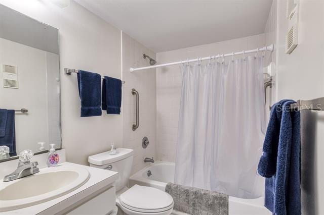 31 Catalonia Court E, Saint Augustine, FL 32086 - bathroom with toilet, shower / tub combo with curtain, and vanity
