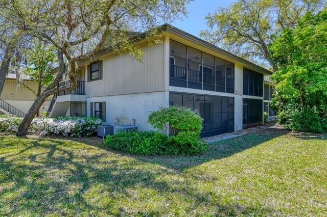 31 Catalonia Court E, Saint Augustine, FL 32086 - view of side of property with a yard, central AC, and a sunroom