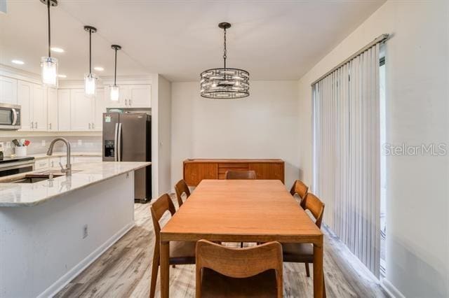 31 Catalonia Court E, Saint Augustine, FL 32086 - dining area with a notable chandelier and light wood-style floors