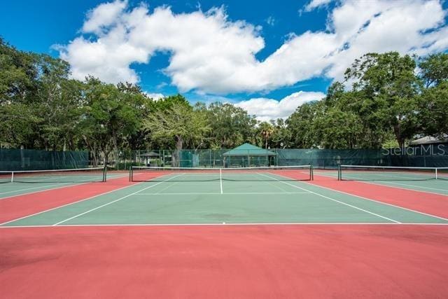 31 Catalonia Court E, Saint Augustine, FL 32086 - view of tennis court with community basketball court and fence