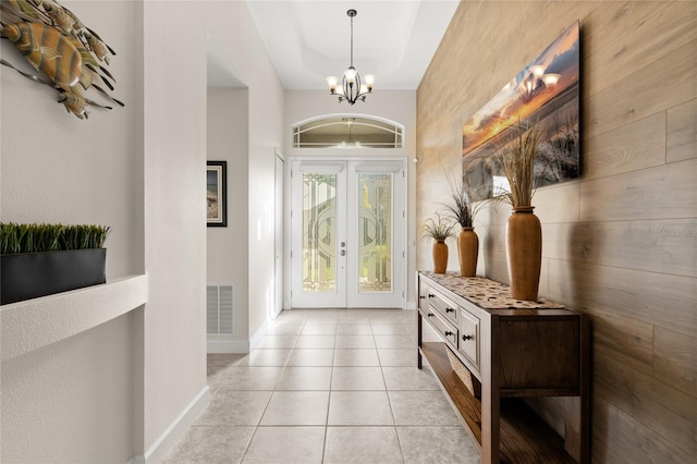 1316 Harwick Ln, Ormond Beach, FL 32174 - entryway with a chandelier, french doors, baseboards, light tile patterned floors, and a tray ceiling
