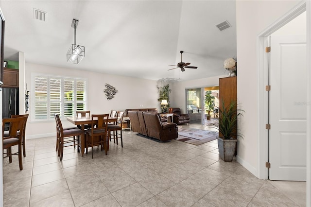 1316 Harwick Ln, Ormond Beach, FL 32174 - dining space featuring ceiling fan, light tile patterned floors, baseboards, and vaulted ceiling
