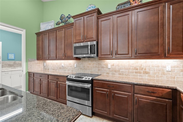 1316 Harwick Ln, Ormond Beach, FL 32174 - kitchen featuring stainless steel appliances, tasteful backsplash, and light stone counters