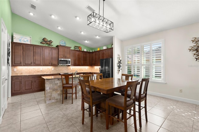 1316 Harwick Ln, Ormond Beach, FL 32174 - dining space with lofted ceiling, light tile patterned floors, baseboards, and recessed lighting