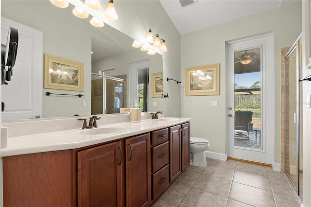 1316 Harwick Ln, Ormond Beach, FL 32174 - full bathroom featuring double vanity, a shower stall, toilet, tile patterned flooring, and baseboards