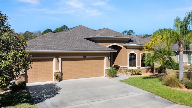 1316 Harwick Ln, Ormond Beach, FL 32174 - view of front facade featuring stone siding, stucco siding, an attached garage, and concrete driveway