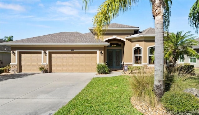 1316 Harwick Ln, Ormond Beach, FL 32174 - view of front of house featuring a garage, stucco siding, french doors, concrete driveway, and stone siding