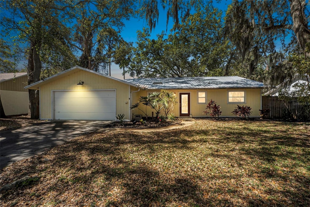 1432 Mollie Rd, Daytona Beach, FL 32114 - ranch-style home featuring a front yard, fence, a garage, and driveway