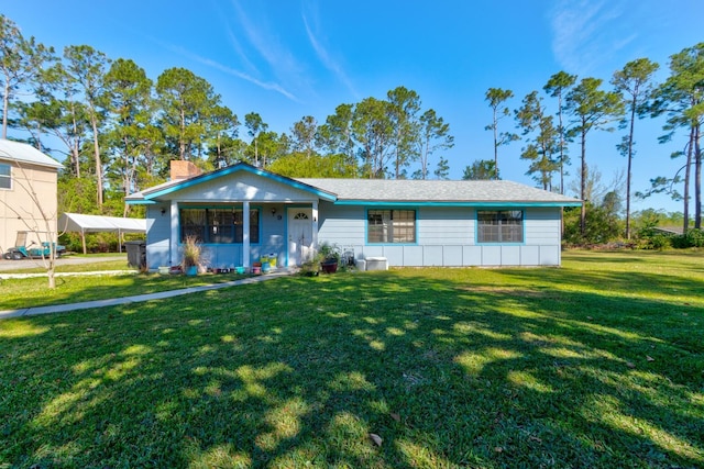 9 Shadow Ln, Ormond Beach, FL 32174 - view of front of house with a front lawn, a detached carport, a porch, and a chimney