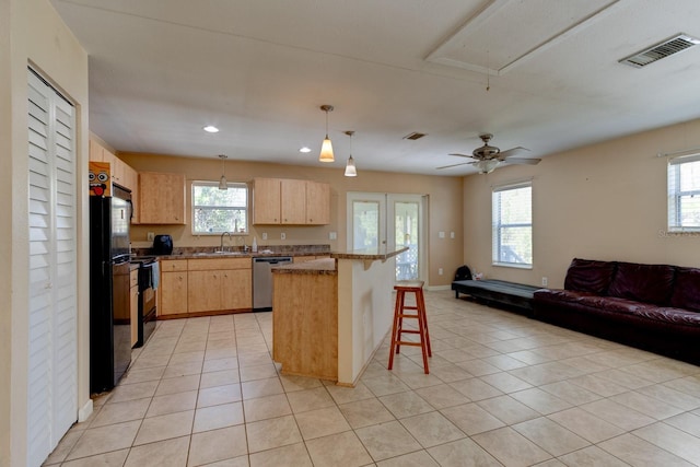 9 Shadow Ln, Ormond Beach, FL 32174 - kitchen with open floor plan, stainless steel dishwasher, light brown cabinetry, a breakfast bar, and a sink