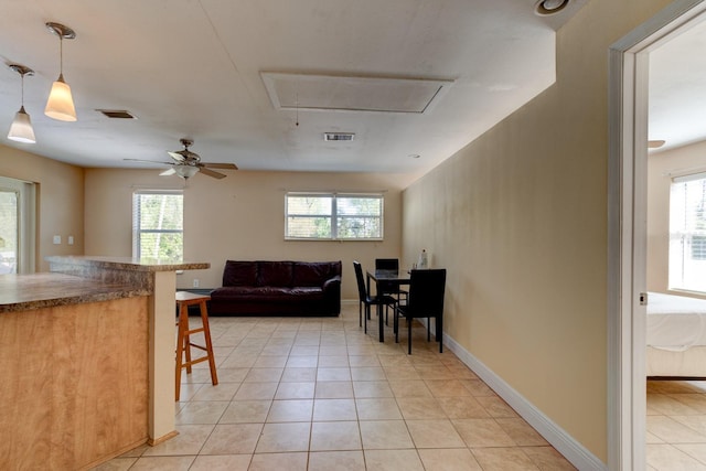 9 Shadow Ln, Ormond Beach, FL 32174 - kitchen featuring a kitchen breakfast bar, light tile patterned flooring, decorative light fixtures, and a ceiling fan