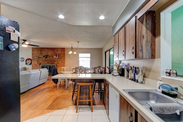 9 Shadow Ln, Ormond Beach, FL 32174 - kitchen with a sink, brown cabinets, light countertops, light tile patterned floors, and recessed lighting