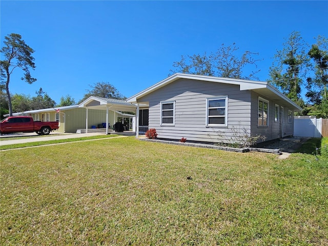 787 Alhambra Ave, Saint Augustine, FL 32086 - view of front of property featuring an attached carport, fence, and a front lawn