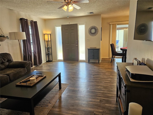 787 Alhambra Ave, Saint Augustine, FL 32086 - living area featuring dark wood-style flooring, a textured ceiling, ceiling fan, and visible vents
