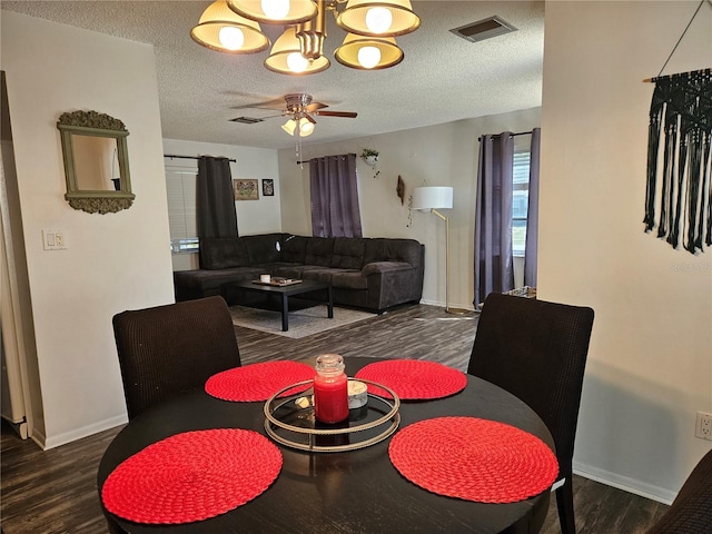 787 Alhambra Ave, Saint Augustine, FL 32086 - dining room featuring visible vents, ceiling fan with notable chandelier, a textured ceiling, and wood finished floors