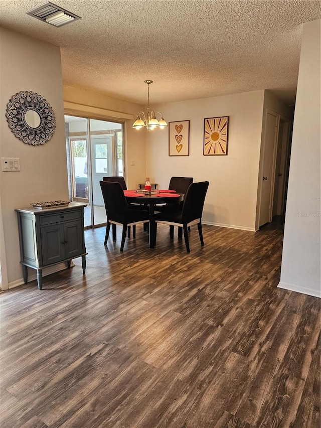 787 Alhambra Ave, Saint Augustine, FL 32086 - dining room featuring a textured ceiling, dark wood-style floors, visible vents, and an inviting chandelier